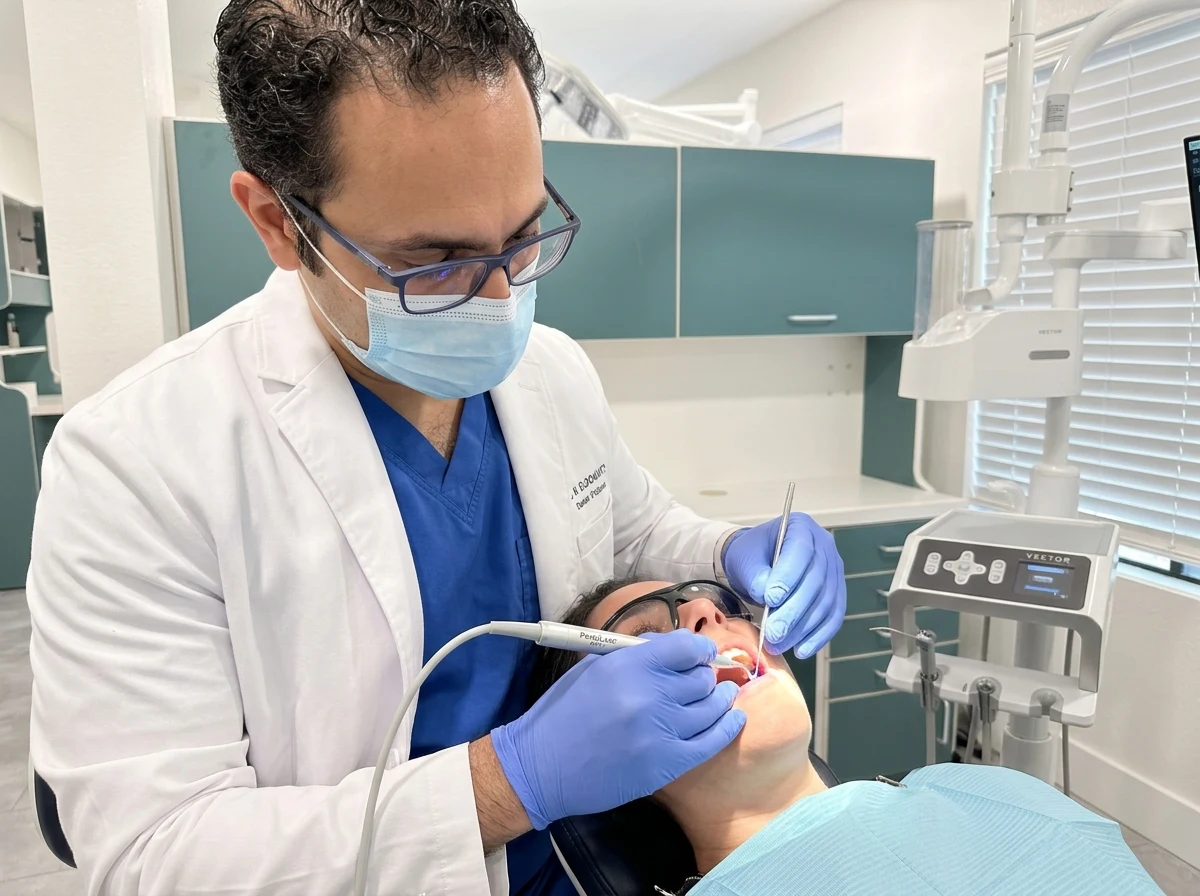 Dr. Walied Eldomiaty performing minimally invasive LANAP laser gum therapy in the Aloha Dental operatory