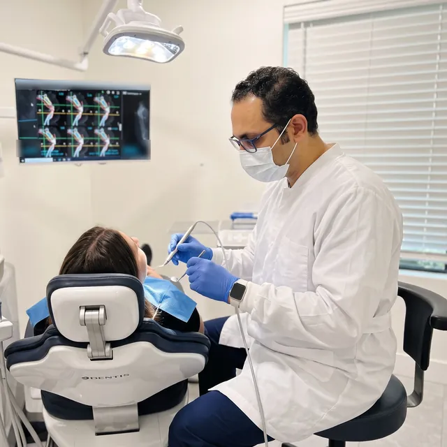 Dr. Walied Eldomiaty, periodontist, providing gum treatment
